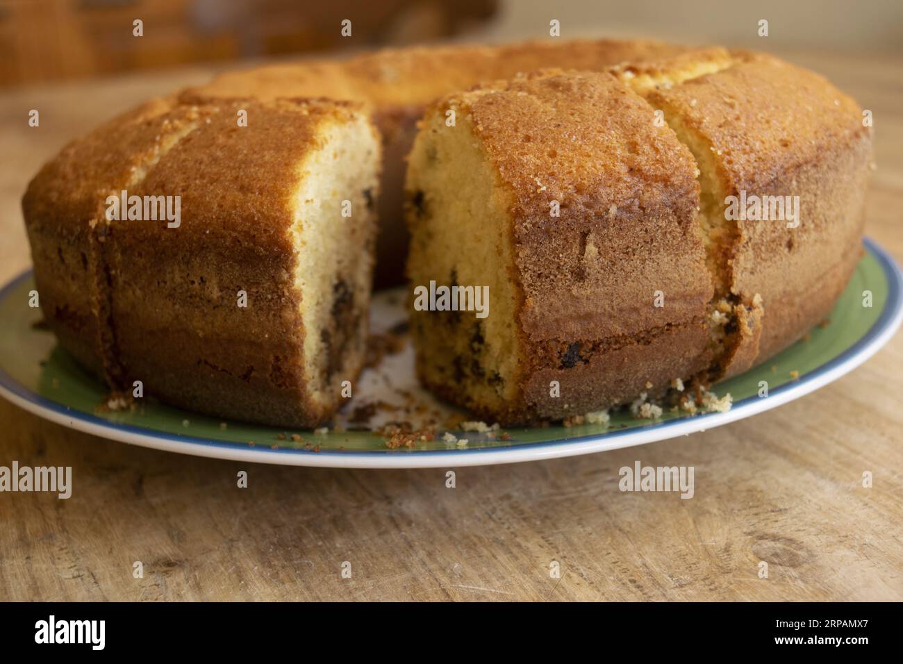 homemade round sponge cake already partially sliced Stock Photo