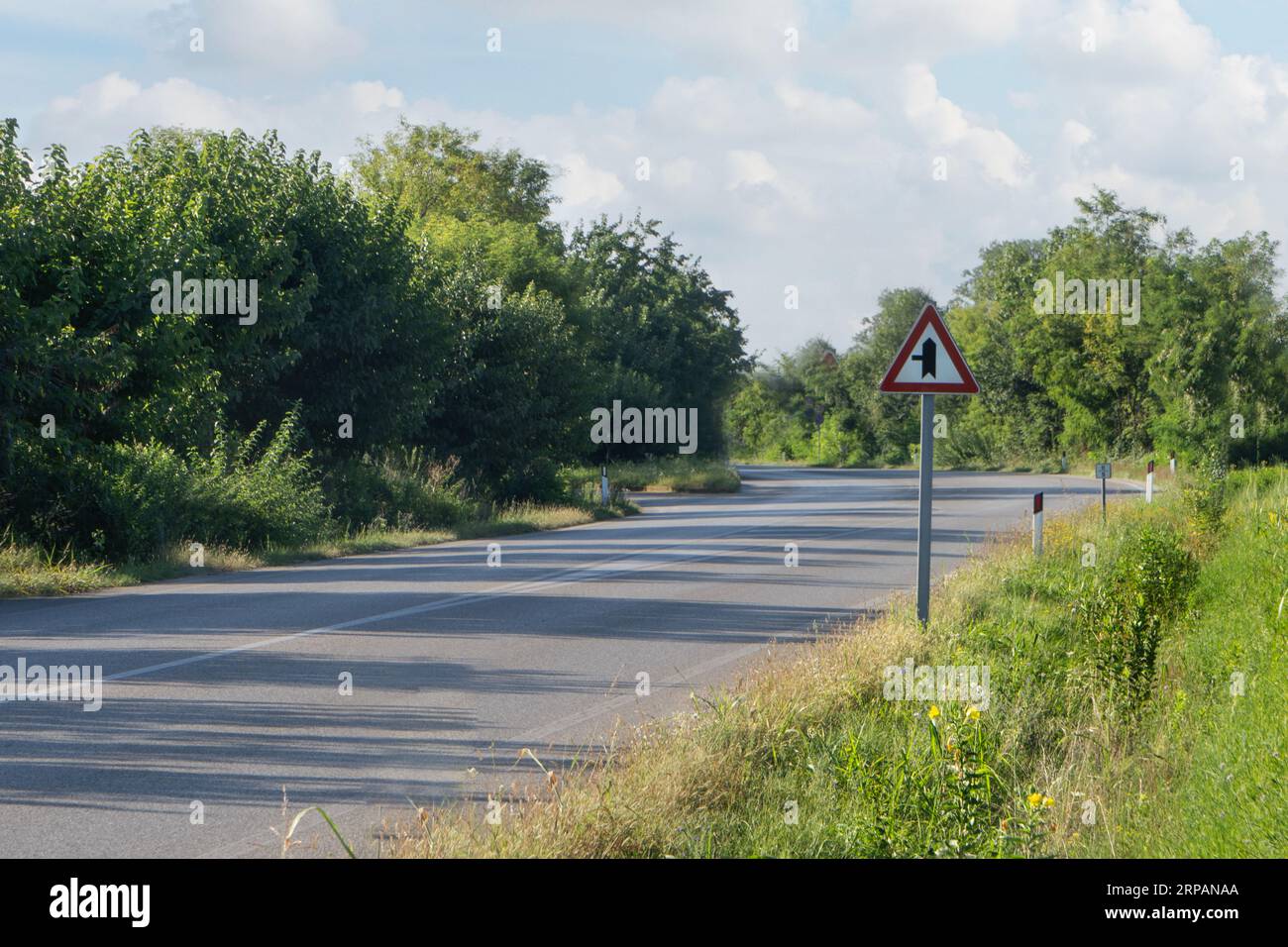 Intersection road sign with right of way on a country road Stock Photo
