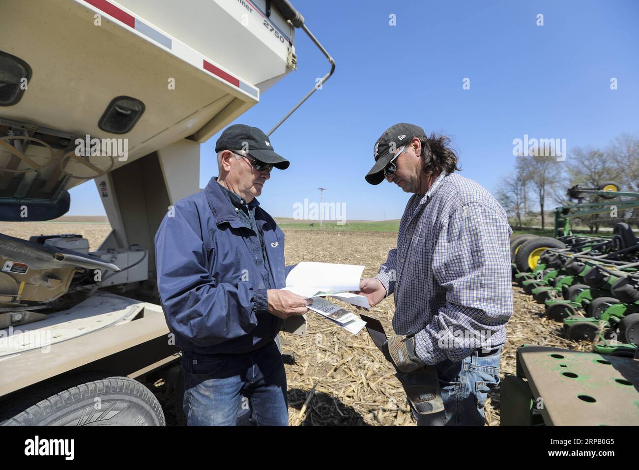 (190523) -- IOWA, May 23, 2019 (Xinhua) -- Bill Pellett and his son Bret checks the purchase record of corn seeds before planting at their family farm in Atlantic of Cass county, Iowa, the United States, April 24, 2019. Bill Pellett knows how to farm, but just like most of his peers across the country, the 71-year-old farmer is feeling less assured of what he could get from a new year of farming, as there appears to be no quick resolution of the year-long trade disputes between the United States and China. TO GO WITH Spotlight: Leading U.S. farming state enters new crop season amid uncertainty Stock Photo