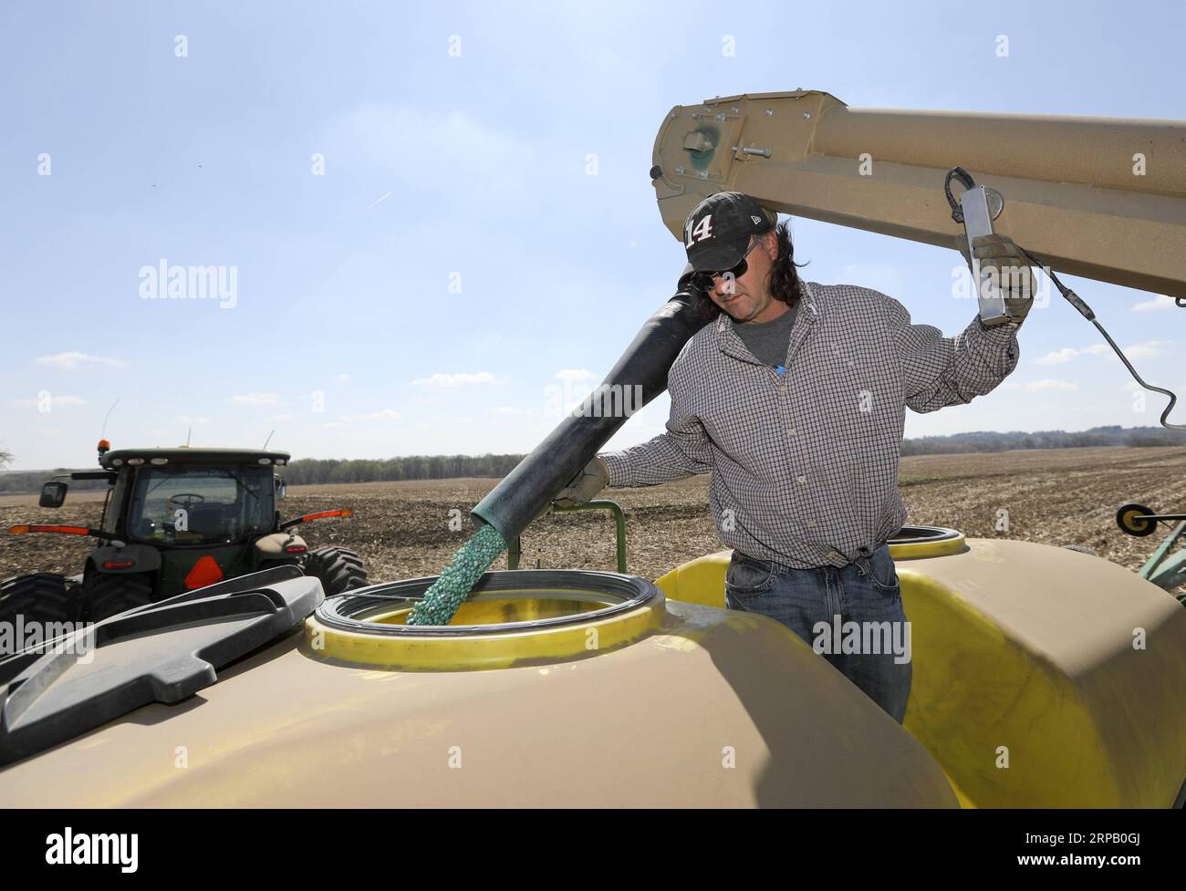 (190523) -- IOWA, May 23, 2019 (Xinhua) -- Bill Pellett s son Bret loads corn seeds into a planter machine at their family farm in Atlantic of Cass county, Iowa, the United States, April 24, 2019. Bill Pellett knows how to farm, but just like most of his peers across the country, the 71-year-old farmer is feeling less assured of what he could get from a new year of farming, as there appears to be no quick resolution of the year-long trade disputes between the United States and China. TO GO WITH Spotlight: Leading U.S. farming state enters new crop season amid uncertainty over trade prospects w Stock Photo