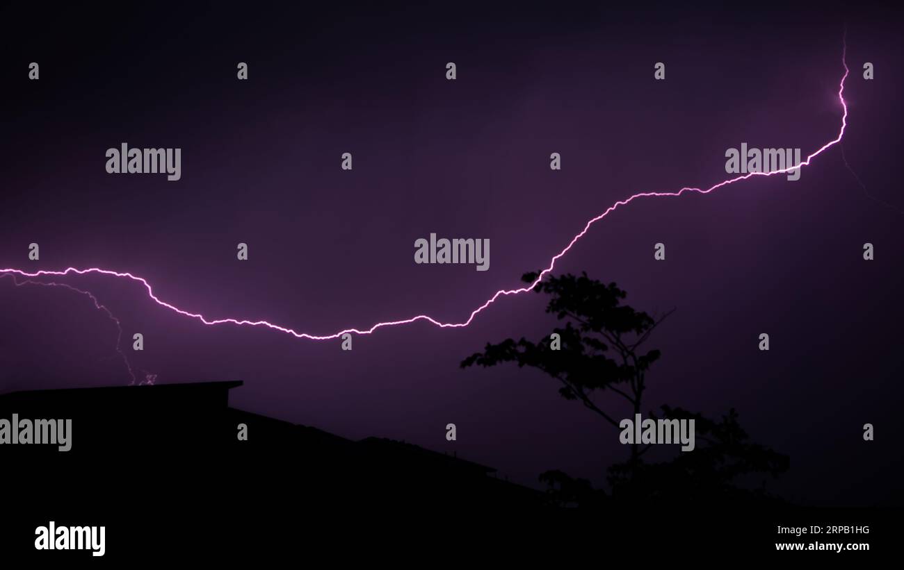 Lightning strike behind storm hi-res stock photography and images - Alamy