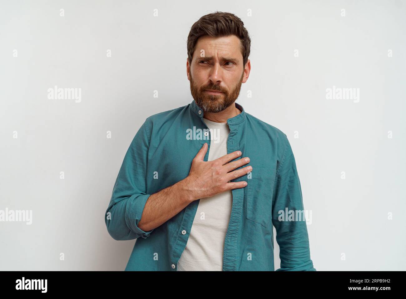 Man feeling sick and nauseous while standing on white background Stock