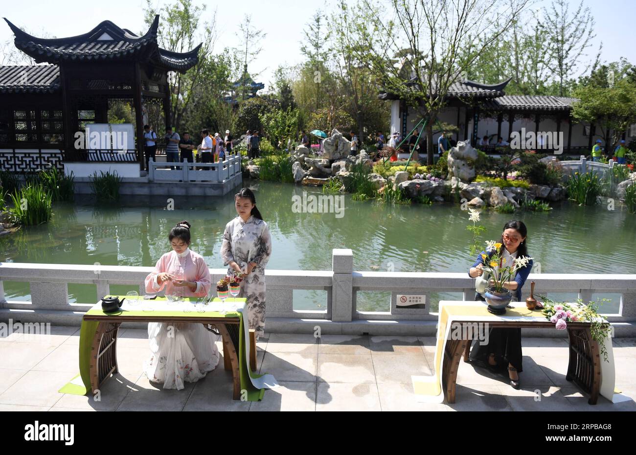 (190603) -- BEIJING, June 3, 2019 (Xinhua) -- Staff perform at Jiangsu Garden during Beijing International Horticultural Exhibition in Beijing, capital of China, June 2, 2019. Located in the east coast of mainland China, Jiangsu in recent years has made great efforts to adjust the ecological layout, optimize the industrial structure and adhere to green development. In 1997, the classical gardens of Suzhou were put on the UNESCO s heritage list. In 2018, the total number of gardens included in the Suzhou Garden List reached 108, and Suzhou was officially transformed from the City of Gardens int Stock Photo