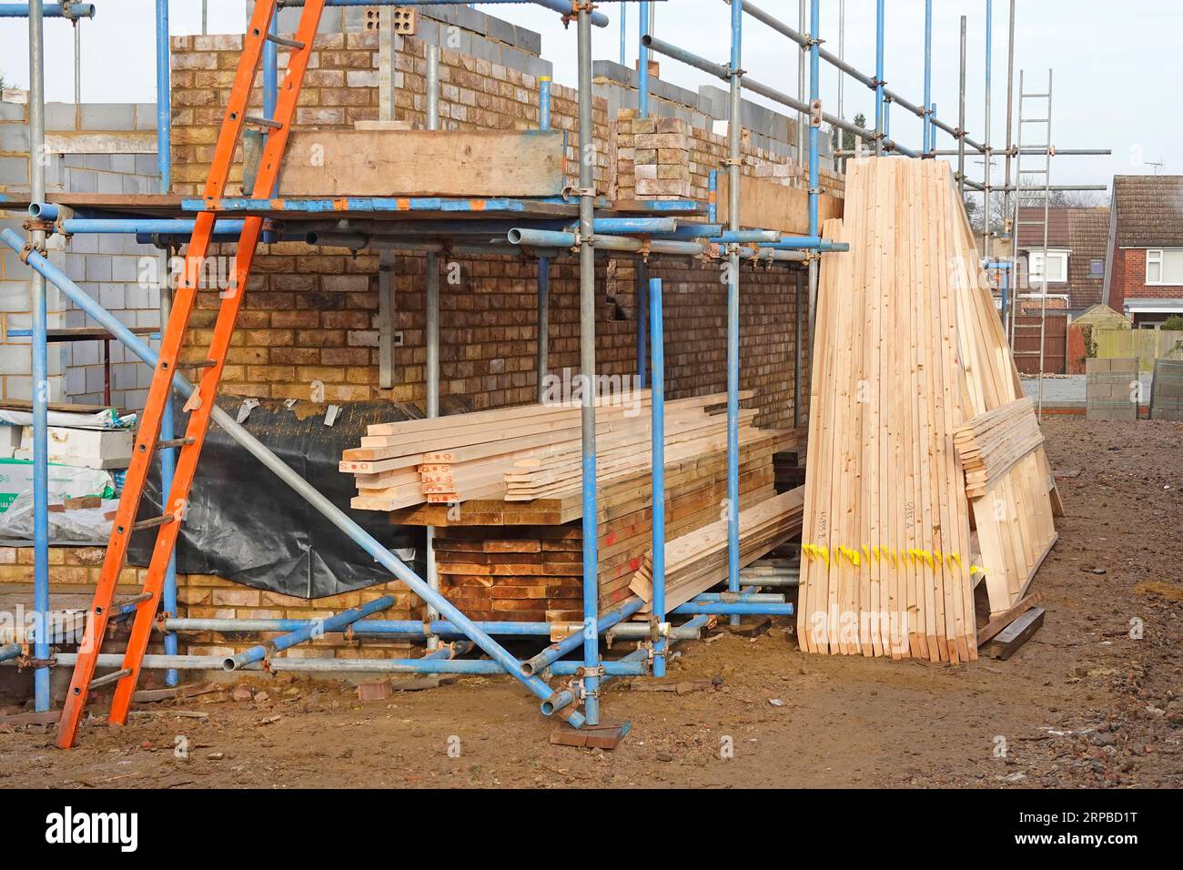 Timber roof trusses factory prefabricated & chemically treated off site delivered with timber floor joists stored ready for building into new house UK Stock Photo
