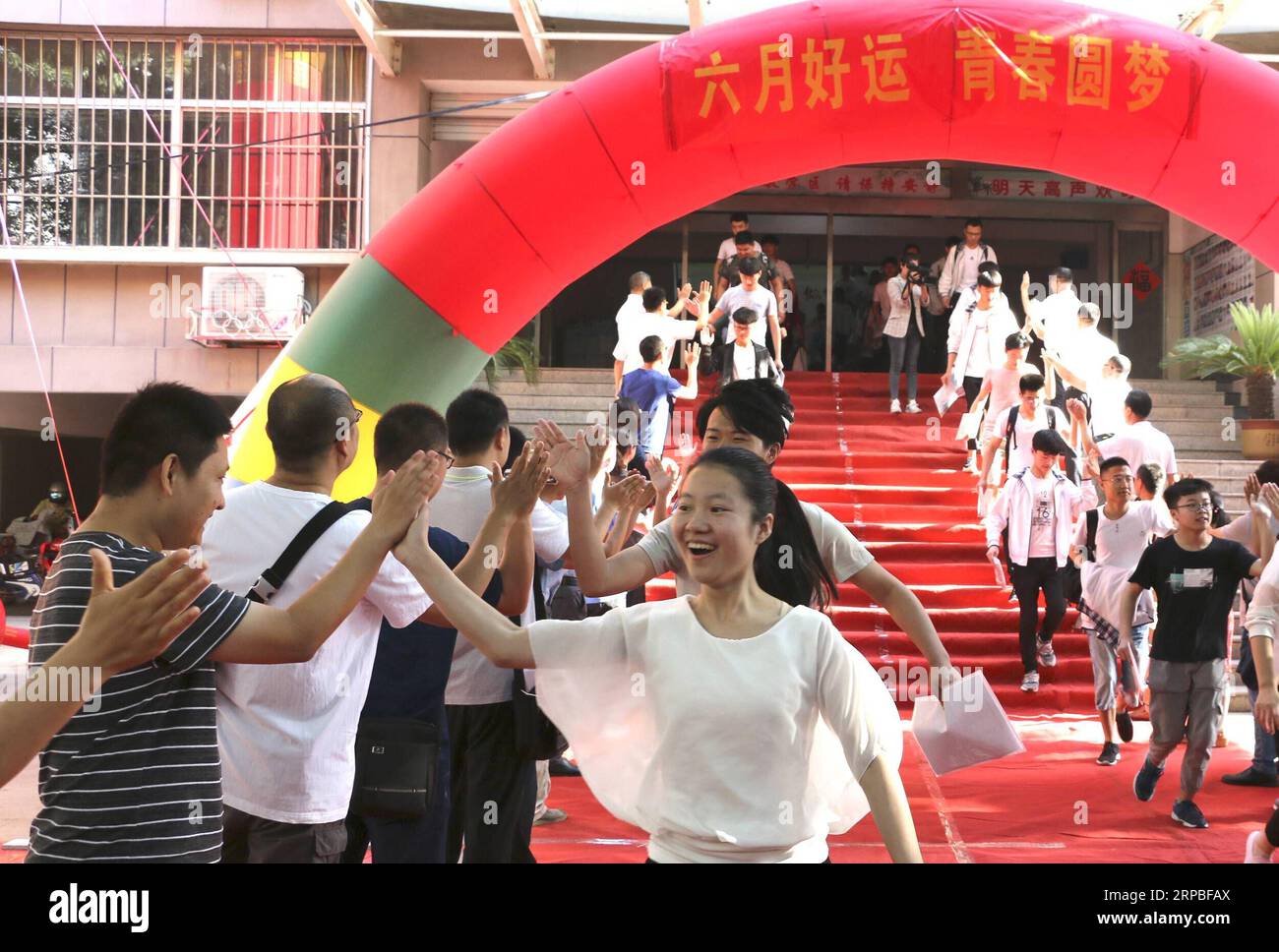 (190607) -- JINING, June 7, 2019 (Xinhua) -- Teachers cheer for examinees at an exam venue at the Experimental Middle School in Zoucheng City, east China s Shandong Province, June 7, 2019. China s national college entrance examination, or Gaokao, started Friday this year. (Xinhua/Wang Qisheng) CHINA-NATIONAL COLLEGE ENTRANCE EXAM (CN) PUBLICATIONxNOTxINxCHN Stock Photo