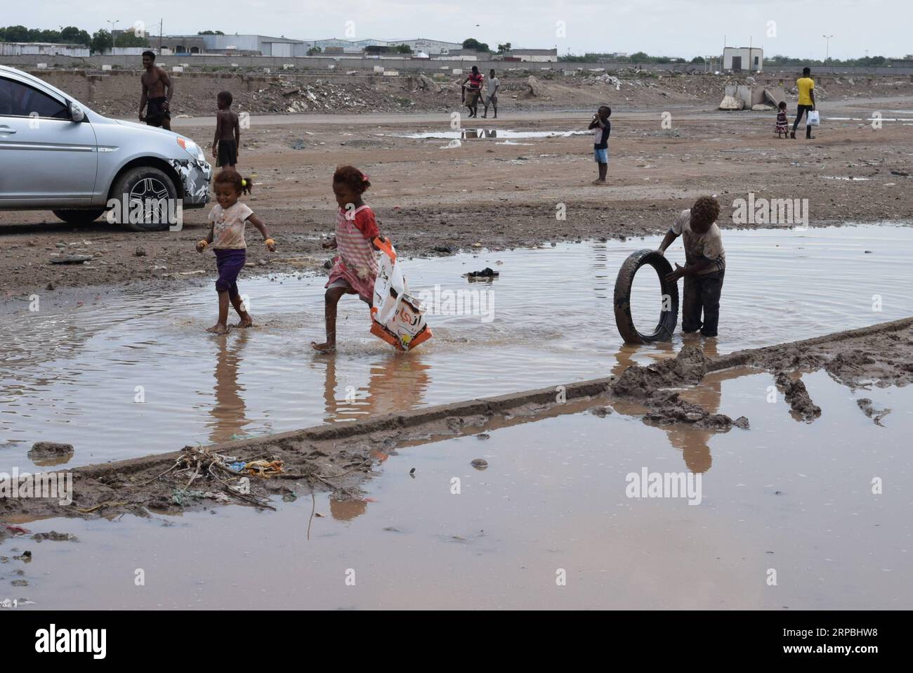 Children play on flooded street hi-res stock photography and