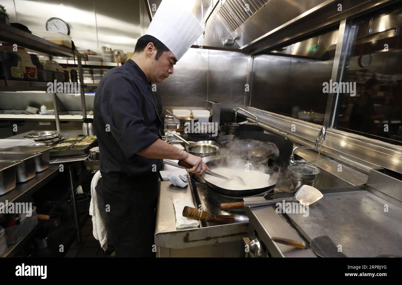 (190610) -- LOS ANGELES, June 10, 2019 (Xinhua) -- A chef works at the kitchen of Bistro Na s in Temple City, Los Angeles, the United States, on June 7, 2019. Bistro Na s in Los Angeles made headlines this week with the announcement that it had been awarded a coveted Michelin Star by the famed Michelin Restaurant Guide. This special ranking broke Michelin s 10-year absence from Los Angeles, and made Bistro Na s the only Chinese restaurant in Southern California to be so honored. (Xinhua/Li Ying) U.S.-LOS ANGELES-CHINESE CUISINE-BISTRO NA S PUBLICATIONxNOTxINxCHN Stock Photo