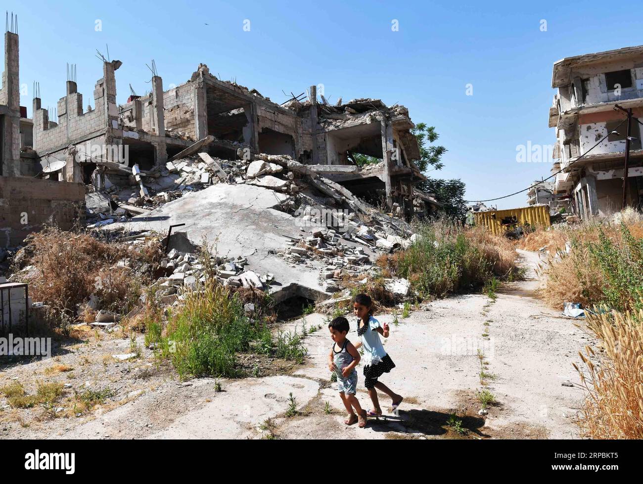 (190611) -- HOMS, June 11, 2019 -- Children of Kamal Shtaiwi play near their house in the Wadi al-Sayeh street in the central city of Homs, Syria, May 29, 2019. Kamal Shtaiwi, 58, enjoys returning to his home with his wife and four children, even though it is surrounded by the destruction of war. TO GO WITH Feature: Displaced Syrian family back home, sweet home amid rubble ) SYRIA-HOMS-DISPLACED SYRIAN FAMILY-HOME AmmarxSafarjalani PUBLICATIONxNOTxINxCHN Stock Photo