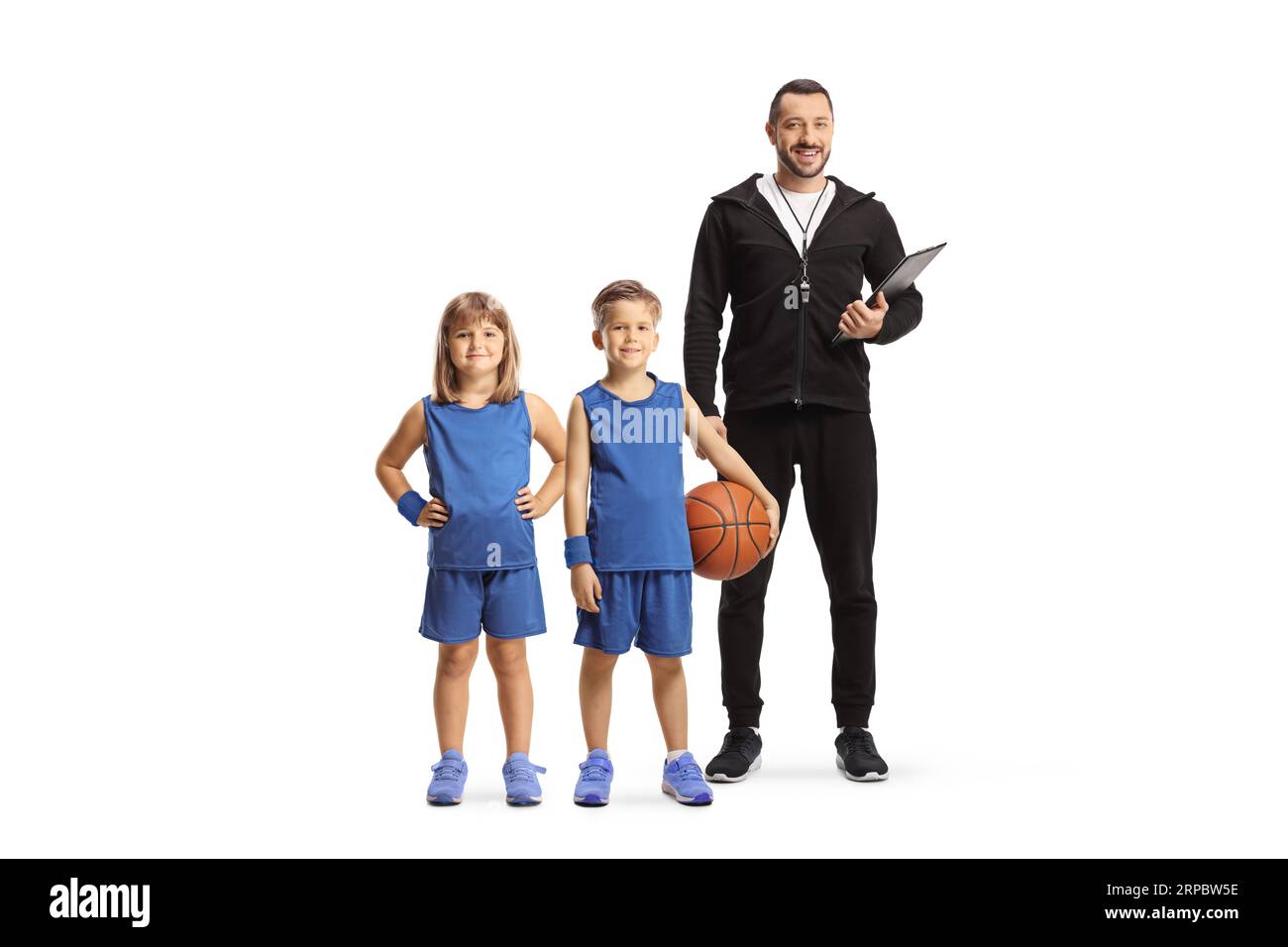 Coach posing with a girl and boy in basketball kits isolated on white