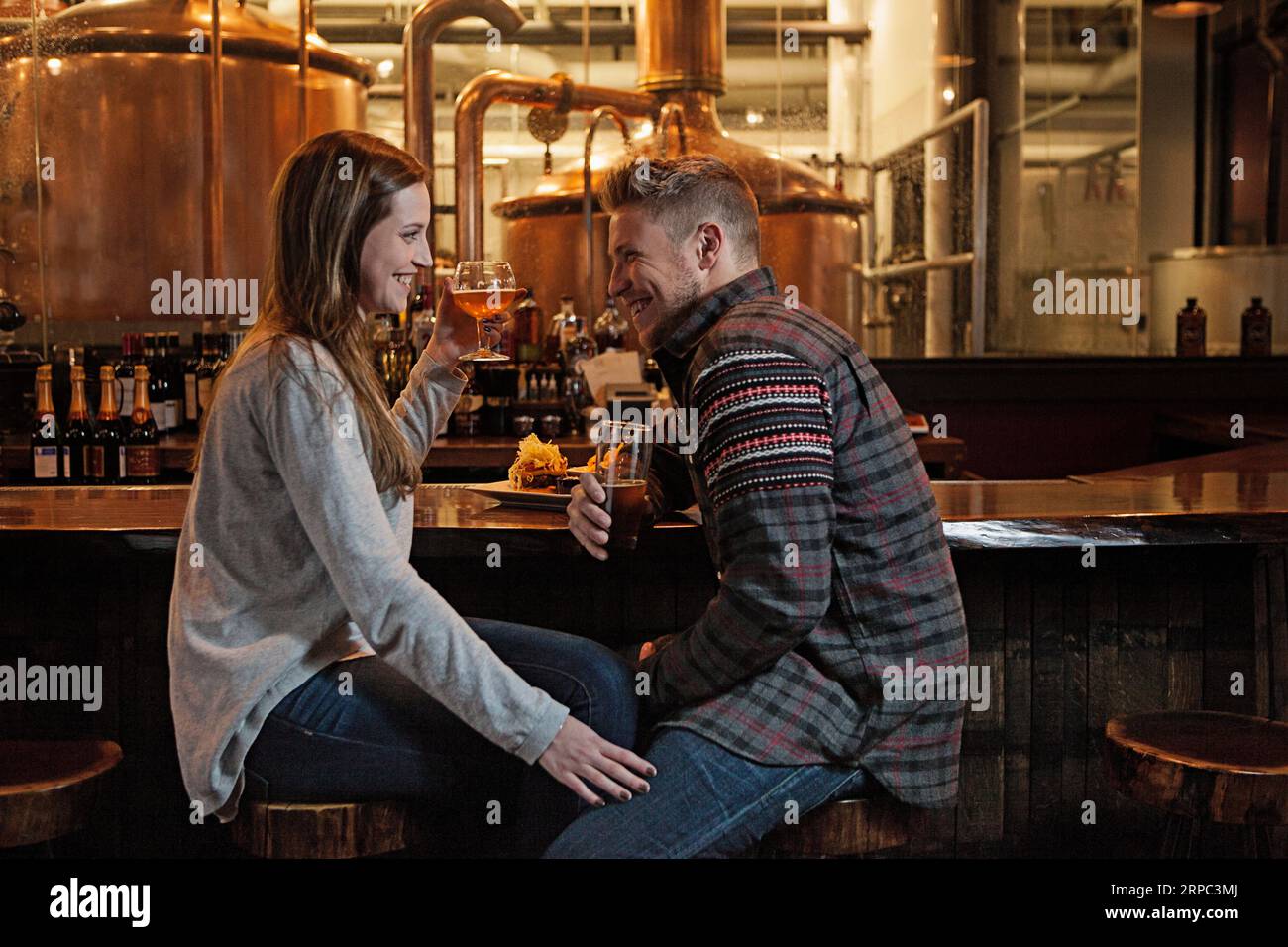 Couple drinking beer in brewery Stock Photo Alamy
