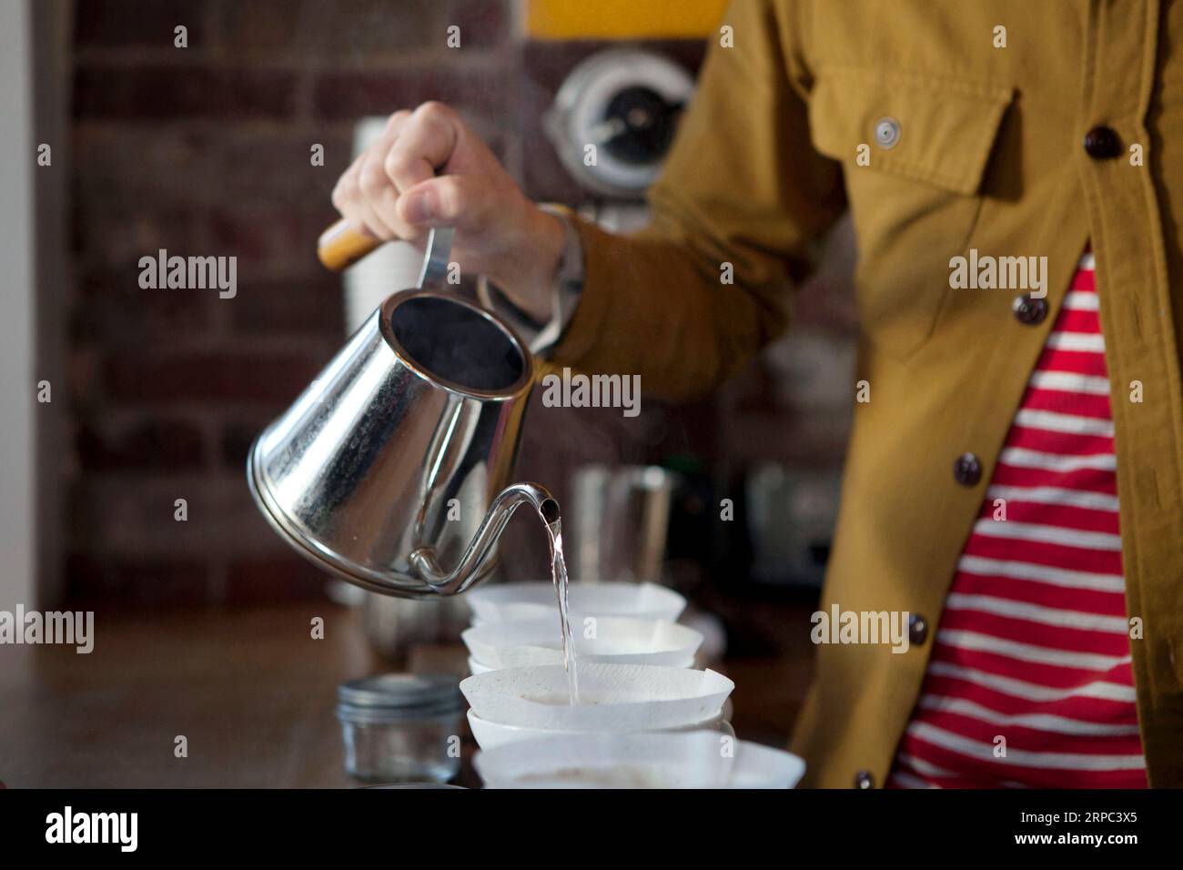 Man pouring water into cup Stock Photo Alamy