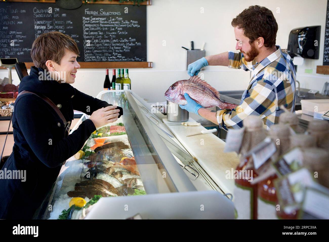 Man selling fish in fish store Stock Photo Alamy