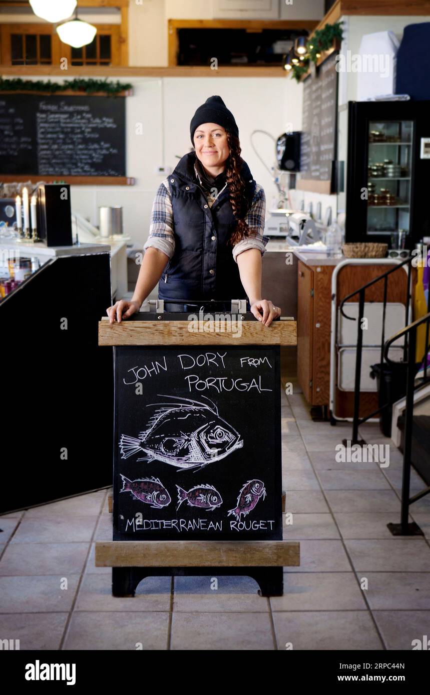 Portrait of woman in fish store Stock Photo