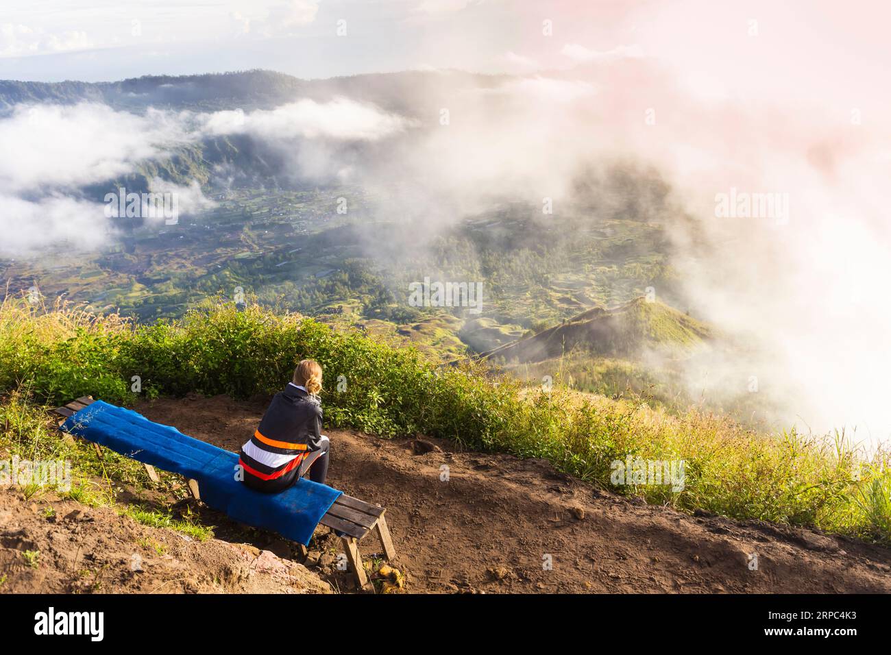 Woman sitting on mountain top hi-res stock photography and images - Alamy