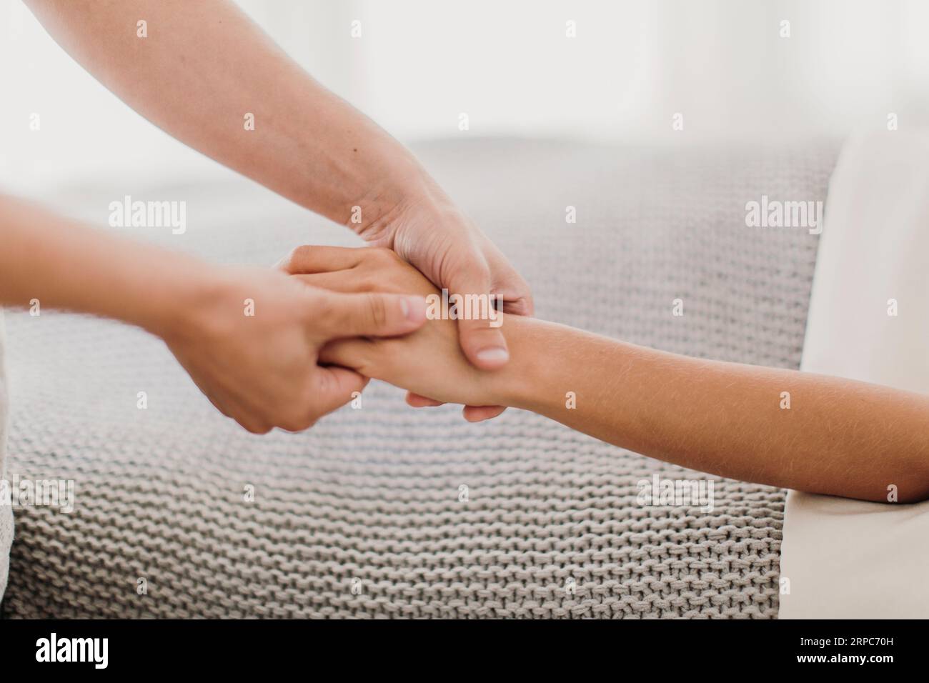 A woman receives a hand massage from a professional massage therapist