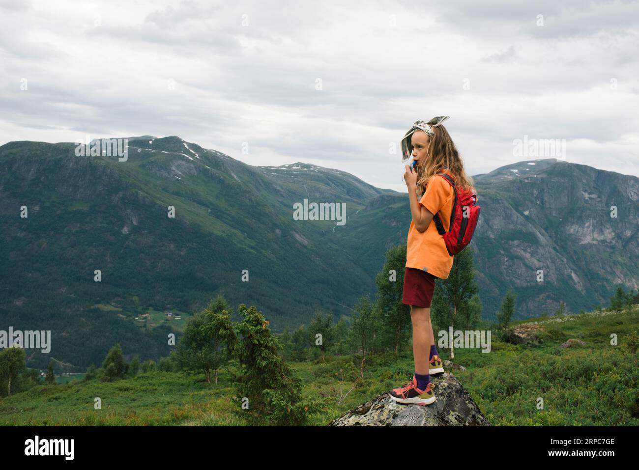 girl using a hydration vest whilst hiking in Norway Stock Photo