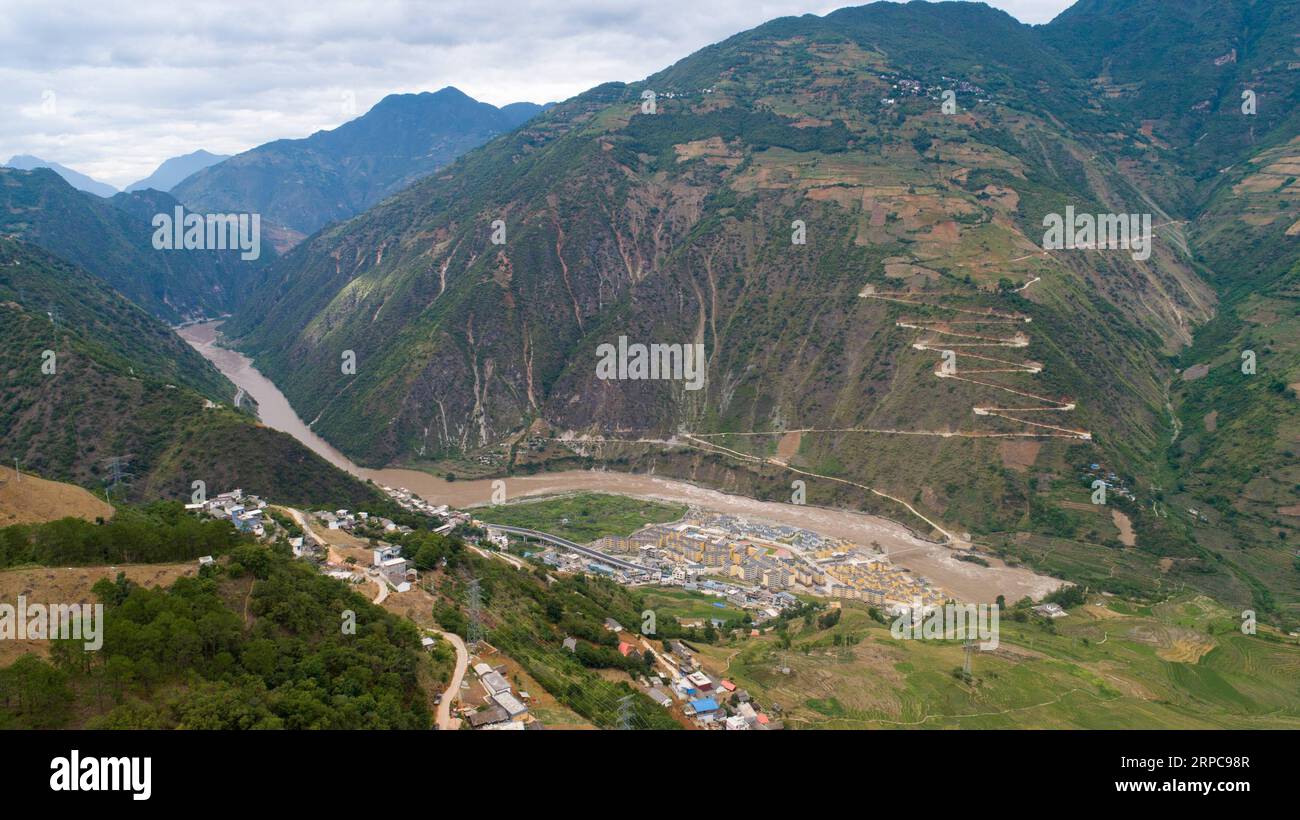 (190628) -- KUNMING, June 28, 2019 -- Aerial photo taken on June 24, 2019 shows a view of Daxingdi Town, Lisu Autonomous Prefecture of Nujiang, southwest China s Yunnan Province. Lisu people have been relocated to a new community from unlivable mountain areas thanks to the poverty alleviation policy by local government. Zhiguo minorities are special members of China s 56 ethnic groups. The term Zhiguo refers to minority groups who, before modernization, had lived in relative isolation and skipped the transition period associated with feudal monarchy. Yunnan is a major concentrated area of Zhig Stock Photo