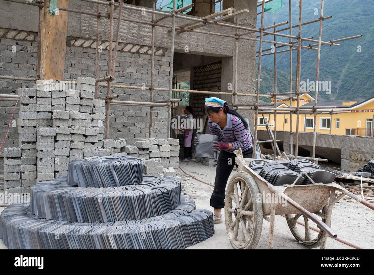 (190628) -- KUNMING, June 28, 2019 -- People work at a resettlement site for people of Lisu ethnic group in Daxingdi Town, Lisu Autonomous Prefecture of Nujiang, southwest China s Yunnan Province, June 26, 2019. Lisu people have been relocated to a new community from unlivable mountain areas thanks to the poverty alleviation policy by local government. Zhiguo minorities are special members of China s 56 ethnic groups. The term Zhiguo refers to minority groups who, before modernization, had lived in relative isolation and skipped the transition period associated with feudal monarchy. Yunnan is Stock Photo