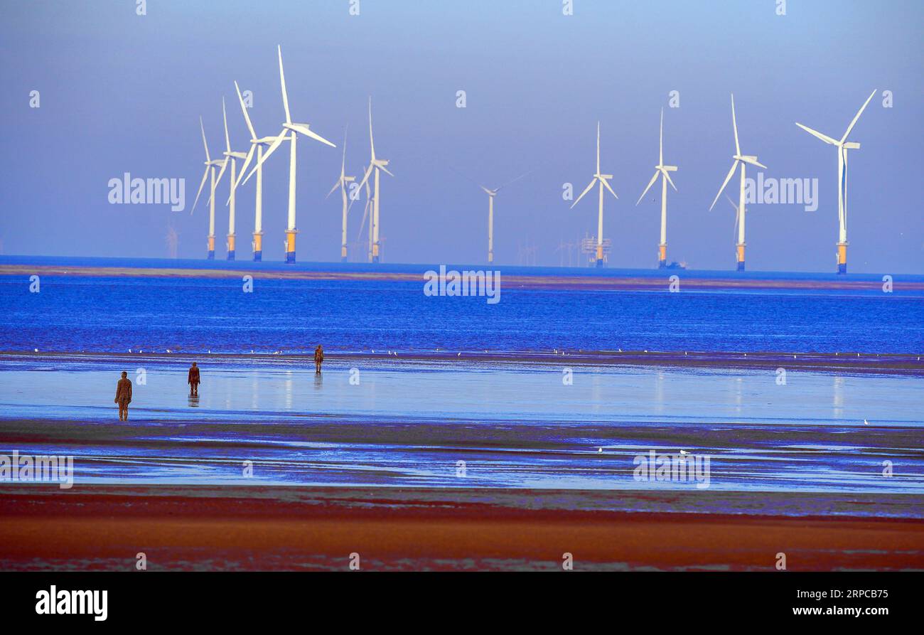 The tide goes out on the beach at Crosby to show the Anthony Gormley