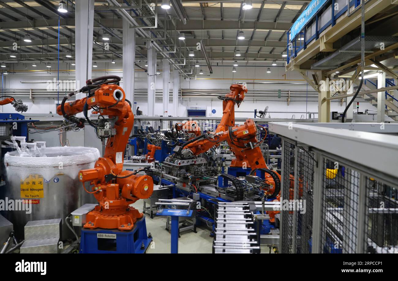 (190701) -- DALIAN, July 1, 2019 -- Robots work at ThyssenKrupp Presta Dalian Co., Ltd. in Dalian, northeast China s Liaoning Province, March 20, 2019. The 2019 Summer Davos Forum is held from July 1-3 in northeast China s coastal city of Dalian. Established by the World Economic Forum in 2007, the forum is held annually in China, alternating between the two port cities of Dalian and Tianjin. Summer Davos has been reshaping the landscape of Dalian s regional economy and strengthening the port s trade with other markets. Dalian has become an international city and a showpiece of China s reform Stock Photo