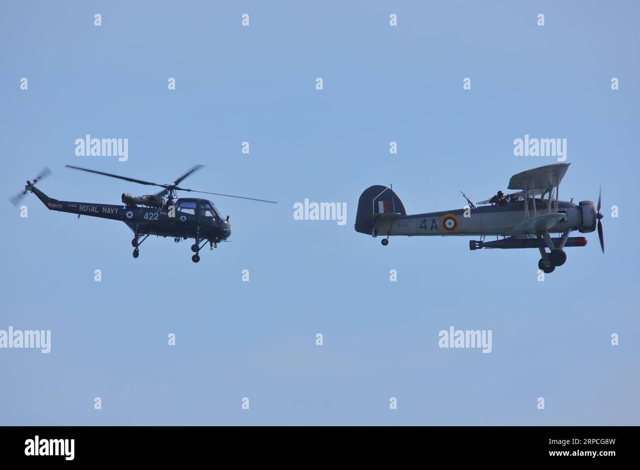 A Westland Wasp helicopter and a Royal Navy Fairey Swordfish torpedo bomber performing their routine at the Bournemouth Air Festival 2023, Bournemouth, UK Stock Photo