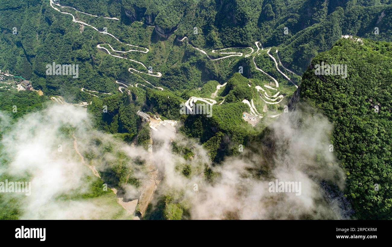 (190708) -- BEIJING, July 8, 2019 -- Aerial photo taken on May 31, 2019 shows a view of the Tianmen Mountain Scenic Area in Zhangjiajie, central China s Hunan Province. Located in central China, Hunan Province is well-known for its varied topography. It abuts the Dongting Lake to the north, and the east, south and west sides of the province are surrounded by mountains, with Wuling and Xuefeng Mountains to the west, Nanling Mountain to the south, Luoxiao and Mufu Mountains to the east. The Xiangjiang, Zijiang, Yuanjiang and Lishui Rivers converge on the Yangtze River at the Dongting Lake in the Stock Photo