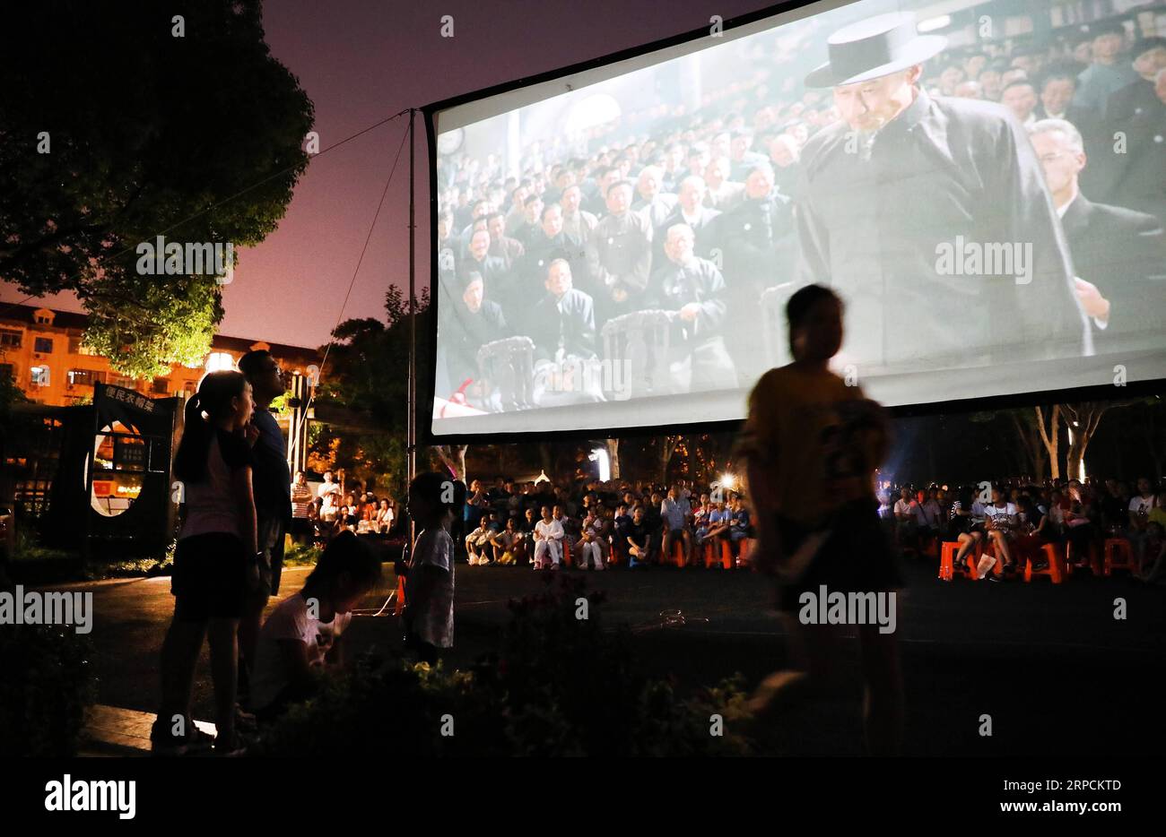 190708 BEIJING July 8 2019 People watch a film shown in an evening open