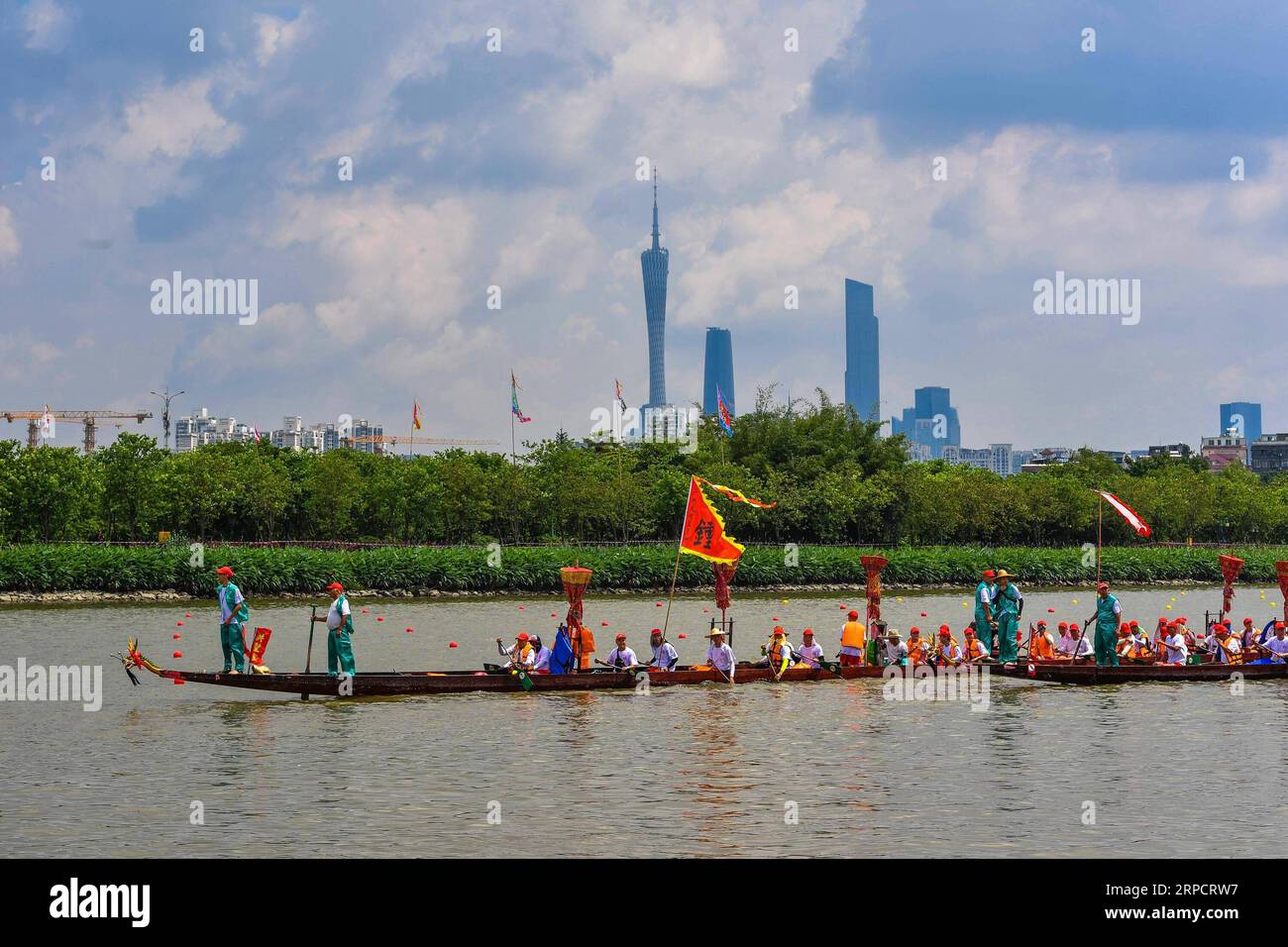 (190712) -- BEIJING, July 12, 2019 -- Participants compete in a dragon boat race near the Haizhu wetland in Guangzhou, capital of south China s Guangdong Province, June 6, 2019. Located in south China, Guangdong Province faces the South China Sea and borders Hunan and Jiangxi provinces to the north. It boasts the well-known Pearl River Delta, which is composed of three upstream rivers and a large number of islands. Due to the climate, Guangdong is famous for a diversified ecological system and environment. In recent years, by upholding the principle of green development, Guangdong has made rem Stock Photo