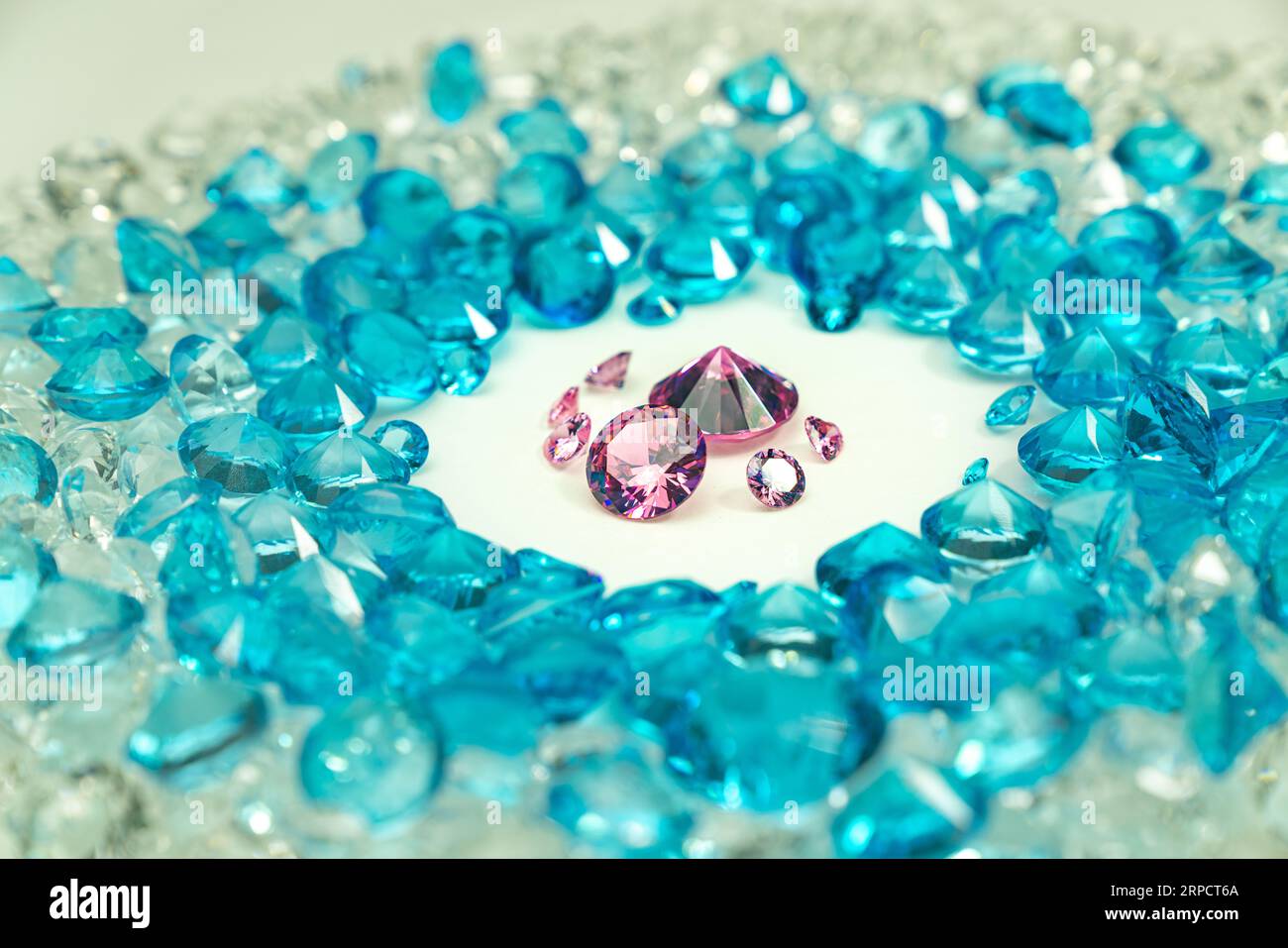 A group of pink diamonds arranged in the middle of blue diamonds in a
