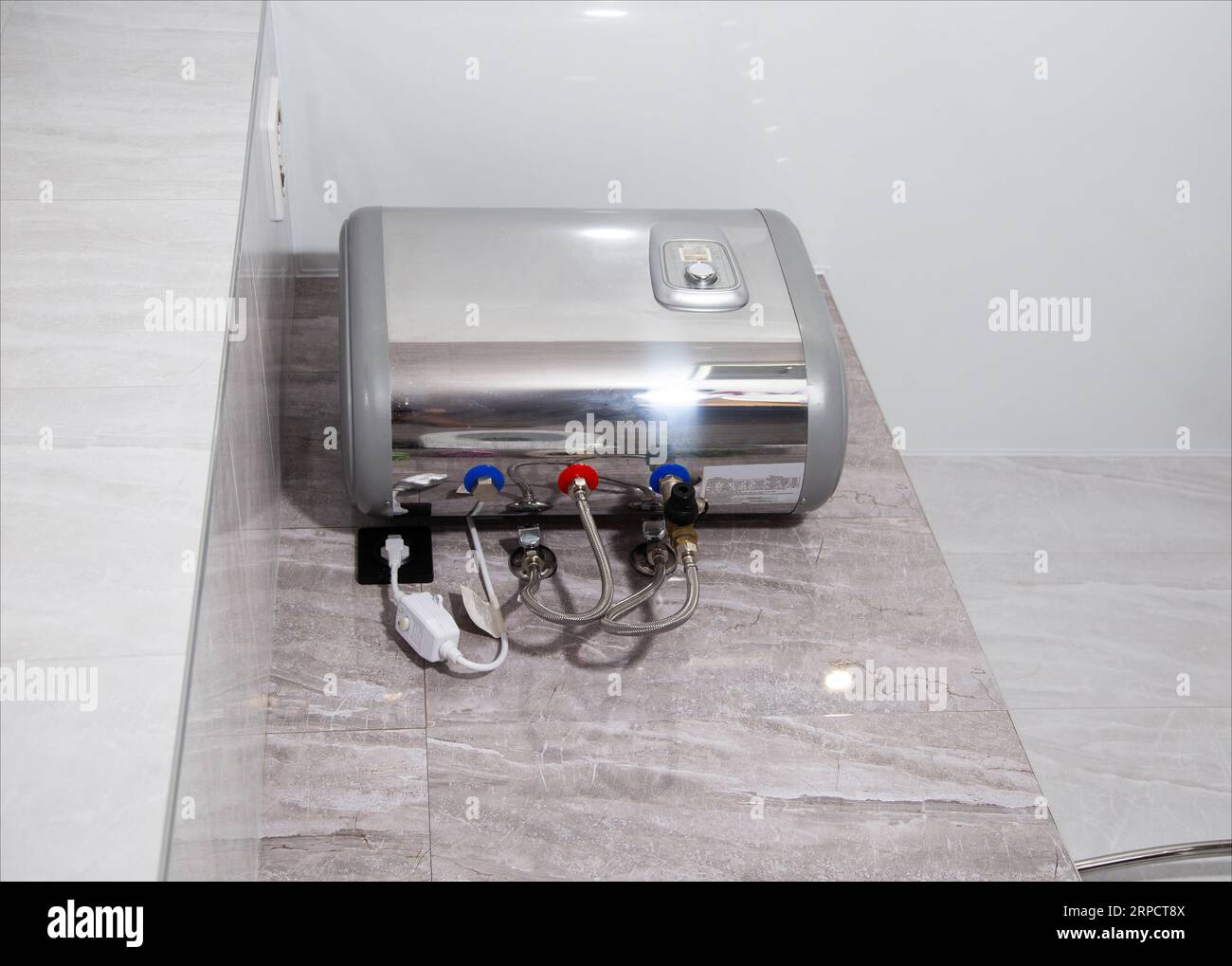 Modern boiler installed in the bathroom for heating water Stock Photo