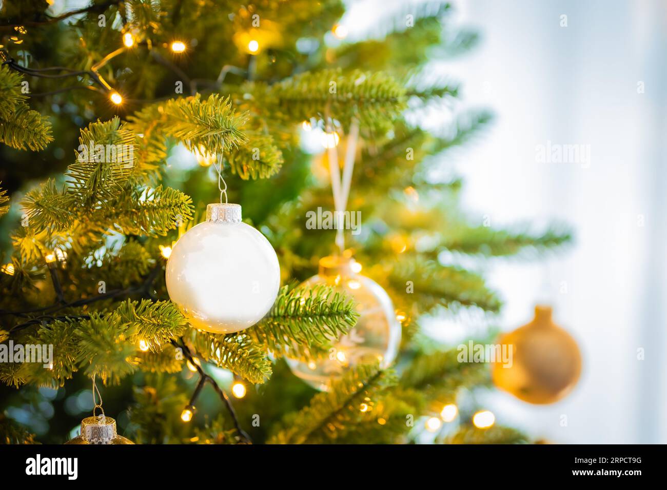 Christmas tree with glass ornaments and warm lights Stock Photo Alamy
