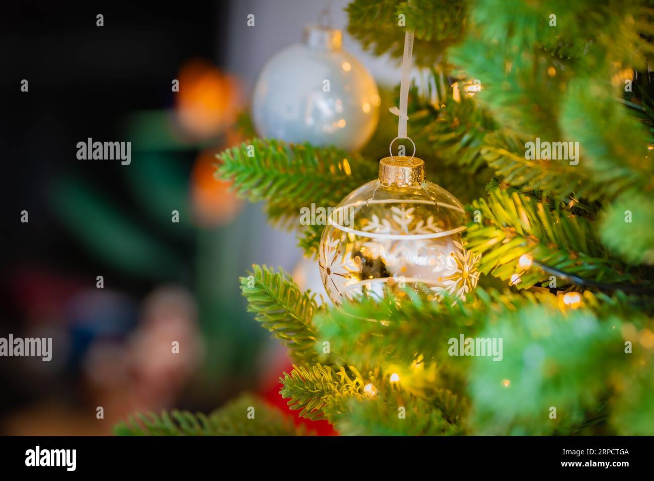 Christmas tree with glass ornaments and warm lights Stock Photo Alamy