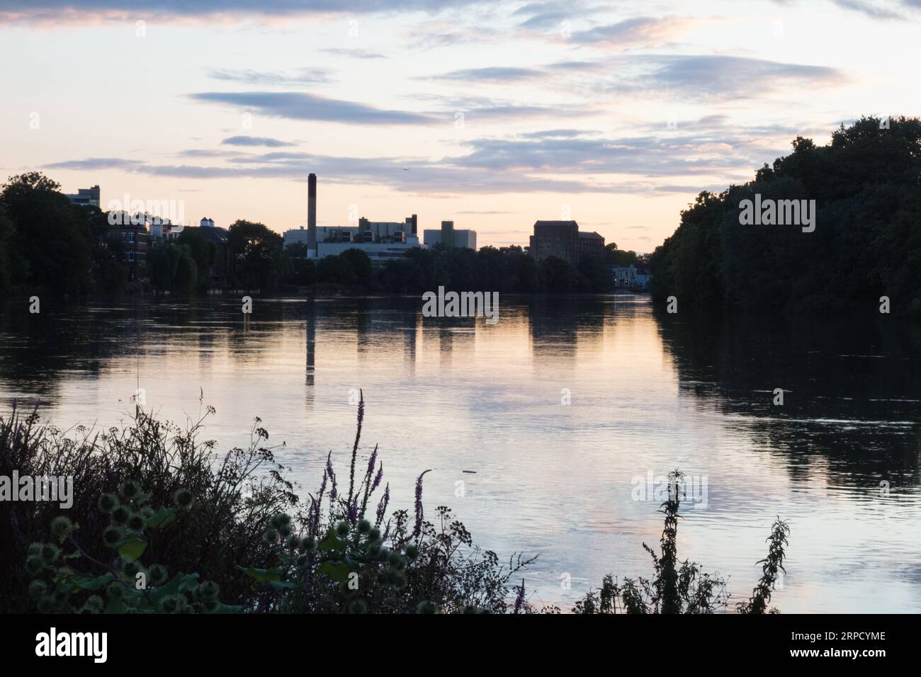 Dusk time reflections of the former Mortlake Brewery in the River Thames, Mortlake, London, England, U.K. Stock Photo