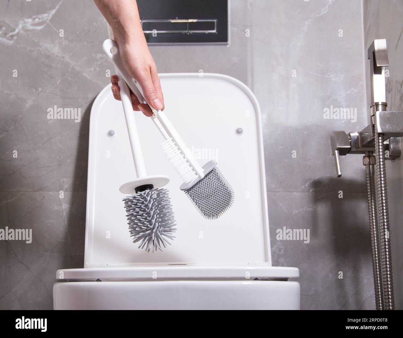 The girl in her hand holds three silicone brushes for the toilet. The