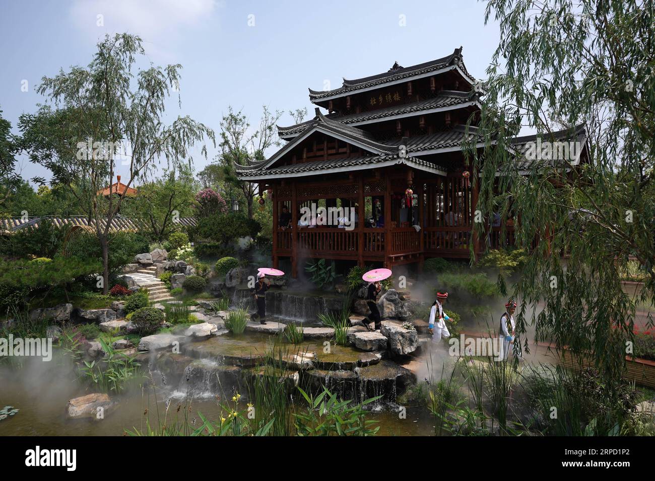 (190719) -- BEIJING, July 19, 2019 -- Tourists visit the Guangxi Garden at the Beijing International Horticultural Exhibition in Beijing, capital of China, July 18, 2019. Located in south China, Guangxi boasts high forest coverage of over 62 percent and various landforms including its picturesque karst mountains. In recent years, following the principle of building ecological civilization, Guangxi authorities uphold green development in agricultural production and poverty alleviation. Meanwhile, the authorities take various measures to improve rural environment including expanding forest cover Stock Photo