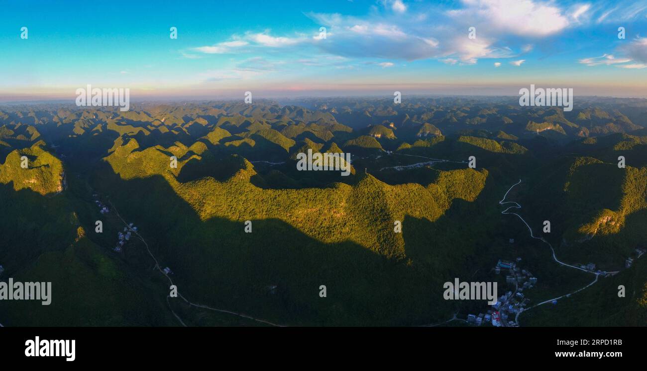 (190719) -- BEIJING, July 19, 2019 -- Aerial photo taken on Aug. 31, 2017 shows the view at the Qibainong national geographic park in Dahua Yao Autonomous County, south China s Guangxi Zhuang Autonomous Region. Located in south China, Guangxi boasts high forest coverage of over 62 percent and various landforms including its picturesque karst mountains. In recent years, following the principle of building ecological civilization, Guangxi authorities uphold green development in agricultural production and poverty alleviation. Meanwhile, the authorities take various measures to improve rural envi Stock Photo