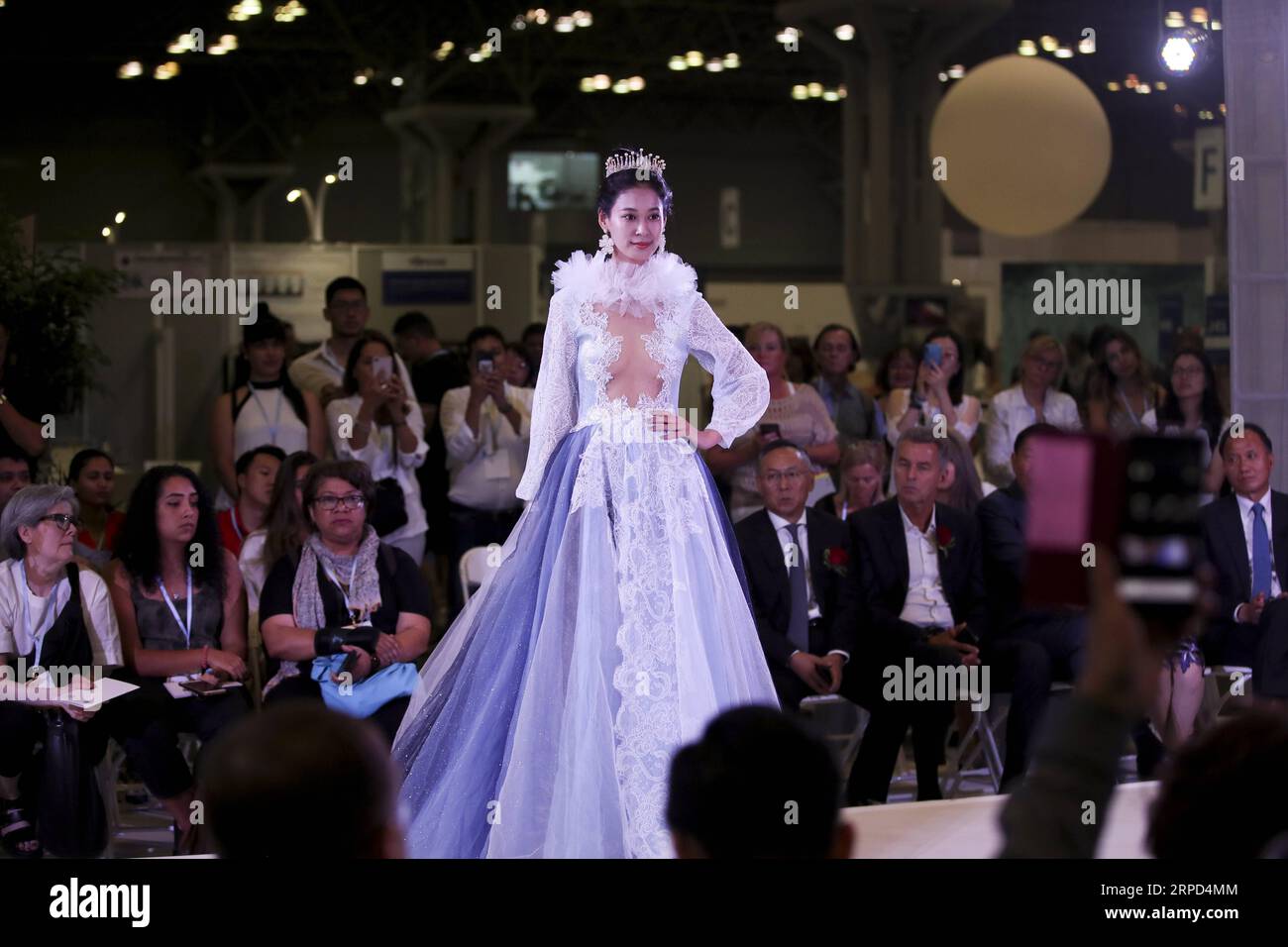 (190722) -- NEW YORK, July 22, 2019 -- A model presents a creation of a Chinese company during the 20th China Textile and Apparel Trade Show in New York, the United States, July 22, 2019. The 20th China Textile and Apparel Trade Show in New York opened on Monday in Manhattan s Javits Center, serving as a platform to showcase the latest industrial trends and help Chinese companies explore the U.S. market. Over 500 Chinese garment, fabric and textile companies are attending this year s trade show, which will run through Wednesday. Another 300 or so companies from 16 countries and regions also jo Stock Photo