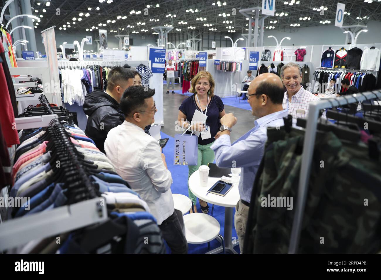 (190722) -- NEW YORK, July 22, 2019 -- People visit a booth of a Chinese company during the 20th China Textile and Apparel Trade Show in New York, the United States, July 22, 2019. The 20th China Textile and Apparel Trade Show in New York opened on Monday in Manhattan s Javits Center, serving as a platform to showcase the latest industrial trends and help Chinese companies explore the U.S. market. Over 500 Chinese garment, fabric and textile companies are attending this year s trade show, which will run through Wednesday. Another 300 or so companies from 16 countries and regions also joined th Stock Photo