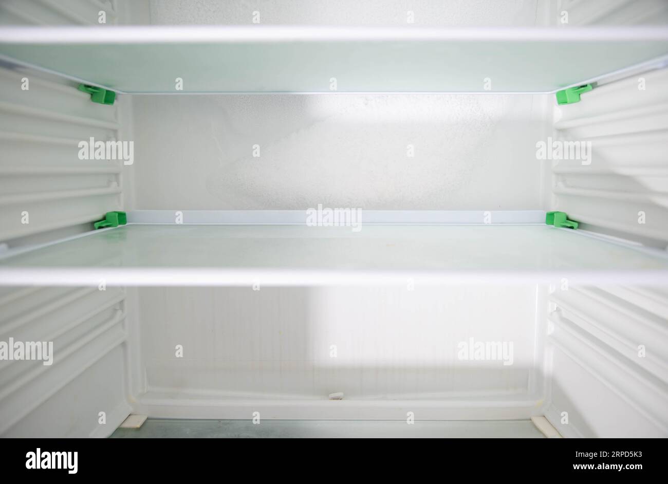 Ice and snow build up on the back wall of the refrigerator