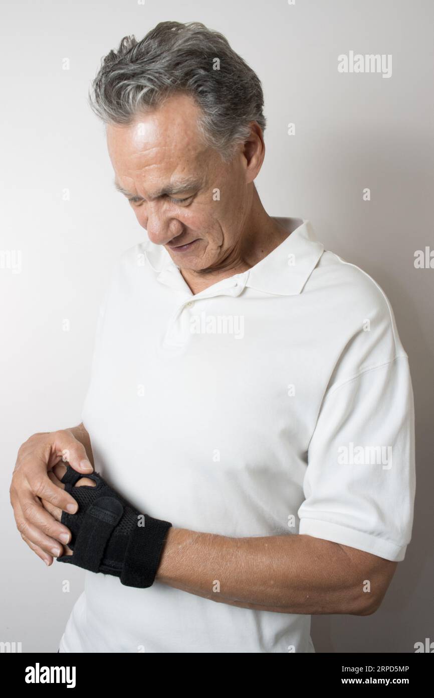 A Hispanic man wearing a wrist brace on his left hand for pain
