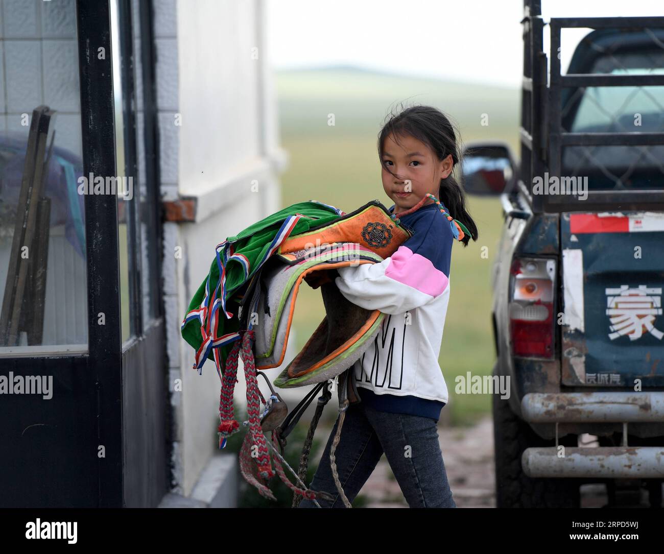 (190723) -- XILIN GOL, July 23, 2019 -- Saihanjiya carries the saddle in East Ujimqin Banner of Xilingol League, north China s Inner Mongolia Autonomous Region, July 20, 2019. Saihanjiya, 10, a well-known young jockey in local town, has a tight schedule for attending various kinds of horse racing in this summer vacation as she really enjoys the speedy riding. Influenced by her father who is a horse trainer, Saihanjiya learned to ride horse when she was seven. After one year of learning, Saihanjiya started to take part in horse racing and achieve good results. Not all gains are achieved without Stock Photo