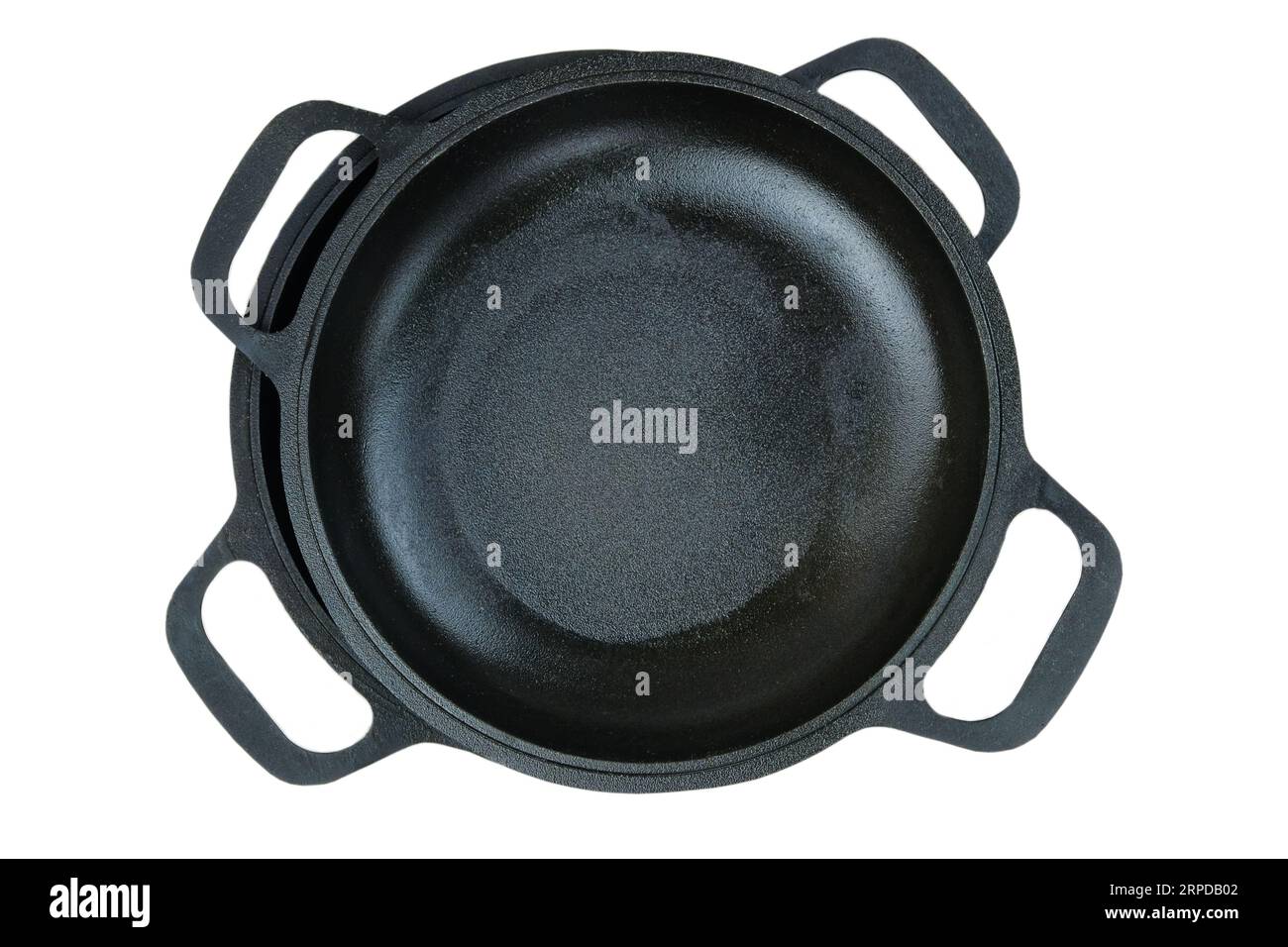 Cast iron pans. Rustic cookware. Kitchenwares isolated on white background.  Top view. Stock Photo