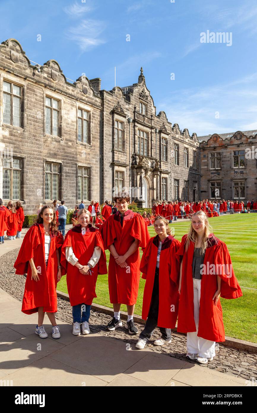 New students at the University of St Andrews wearing red robes gather in St Salvator's College quad before the traditional harbour Pier walk Stock Photo