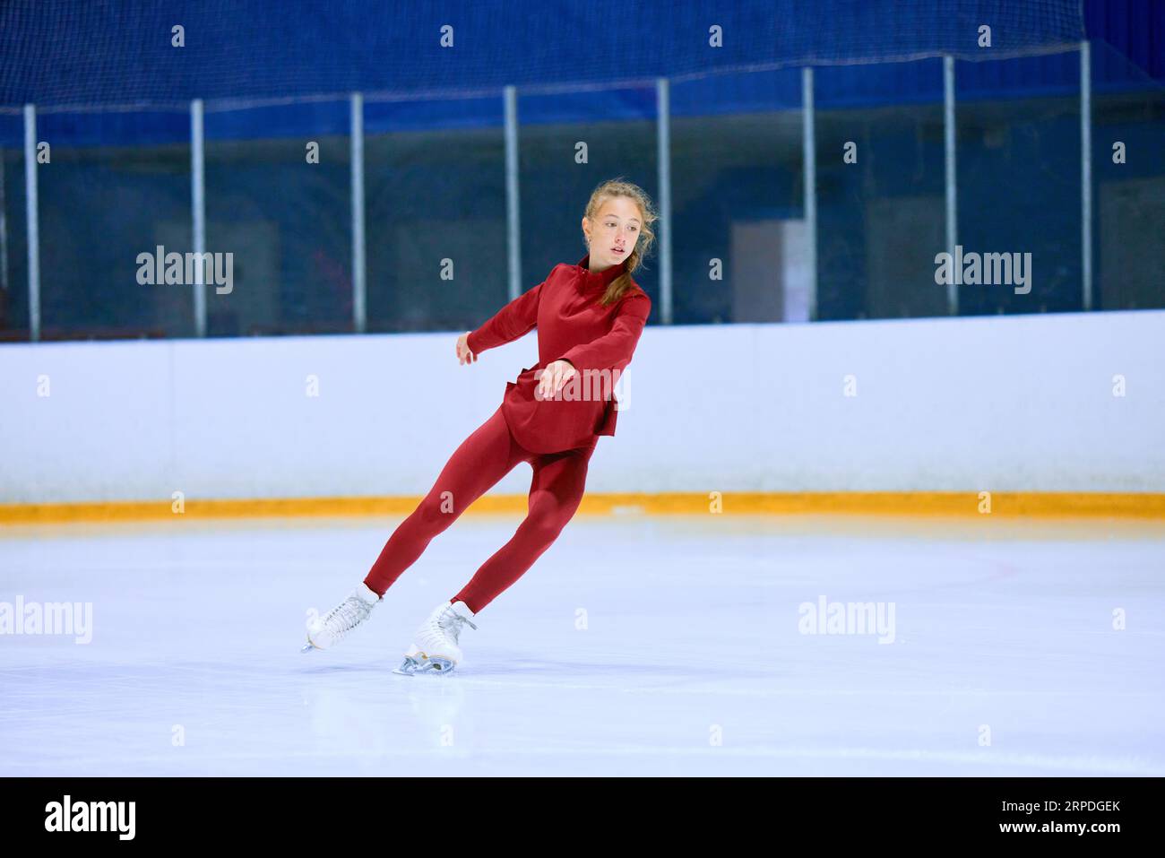 Concentrated and motivated teen girl in red sportswear training