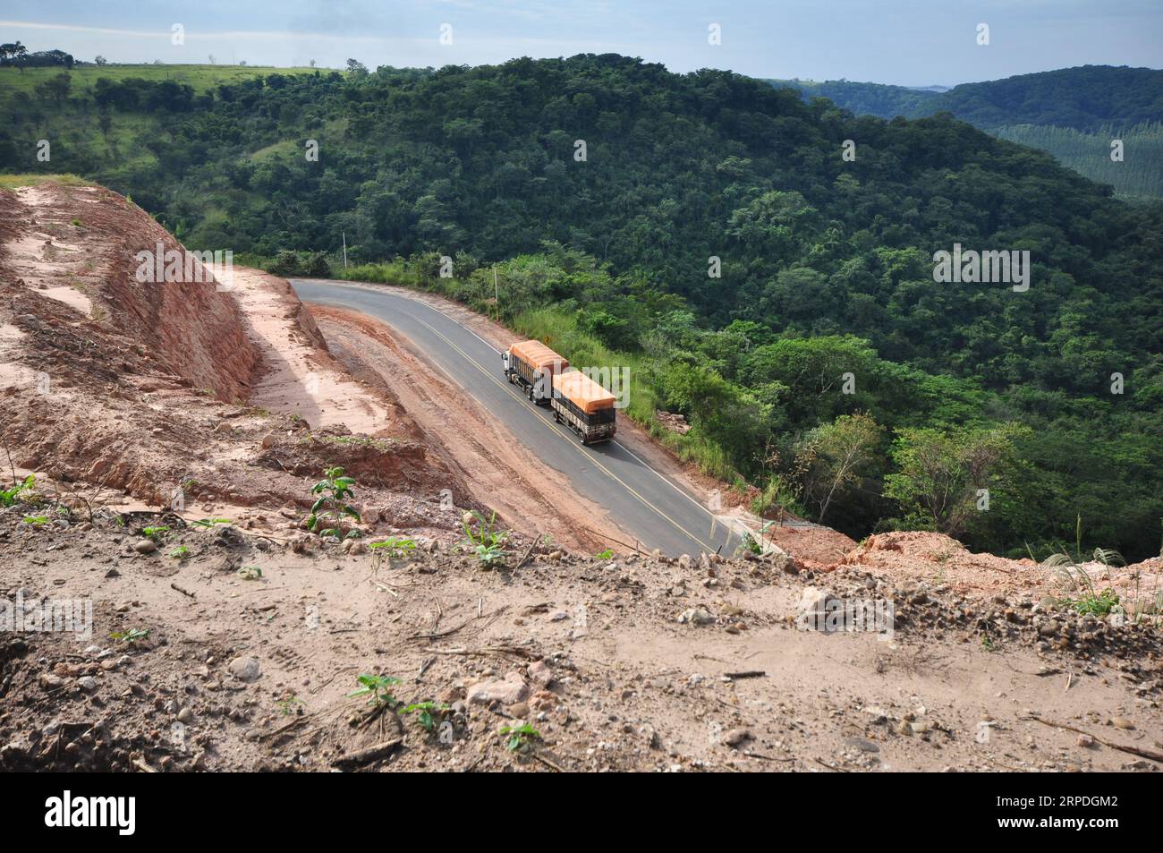 Lookout  with view of curved paved road and transport truck. Panoramic view from the top. Stock Photo