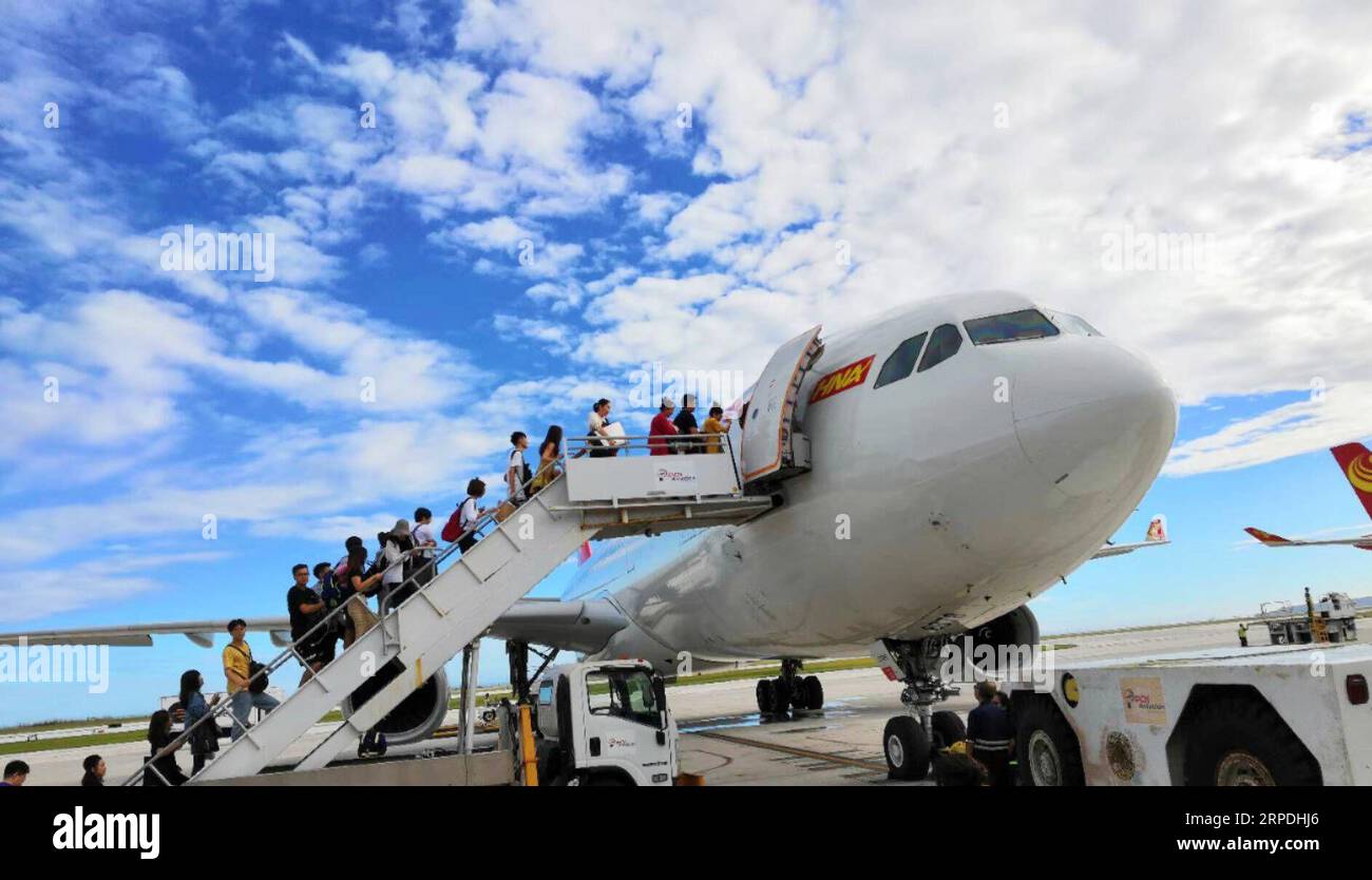 (190805) -- BEIJING, Aug. 5, 2019 (Xinhua) -- Chinese tourists get on board to fly back home in Saipan, the Commonwealth of the Northern Mariana Islands (CNMI), Oct. 28, 2018. Chinese tourists made 149 million overseas trips in 2018, with total spending amounting to 130 billion U.S. dollars, according to a report released by the China Tourism Academy. The data marked a year-on-year increase of 14.7 percent and 13 percent, respectively. According to the United Nations World Tourism Organization, the number of global travelers will exceed 1.8 billion by 2030. China is considered the world s fast Stock Photo