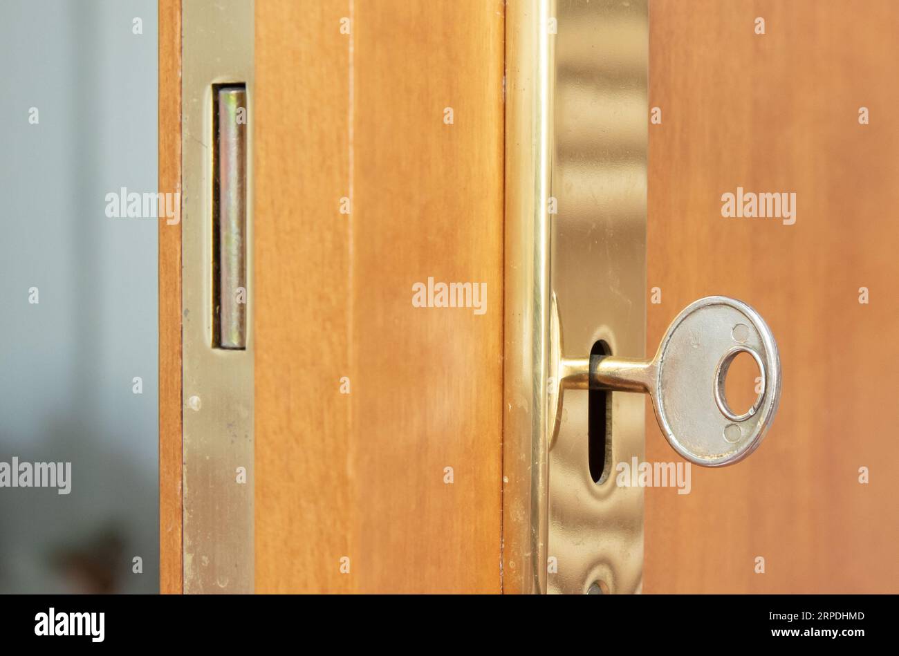 Wooden door with a gold lock and key, selective focus Stock Photo - Alamy