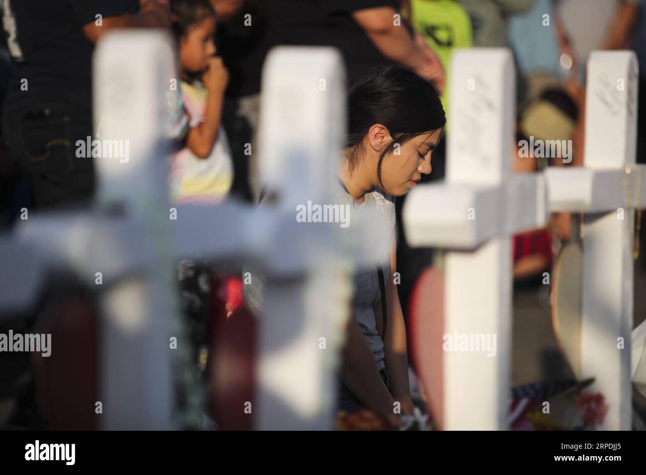 (190806) -- El PASO, Aug. 6, 2019 -- A woman mourns victims in front of crosses with names of victims near the Walmart center where the Saturday s massive shooting took place, in El Paso, Texas, the United States, Aug. 5, 2019. The police department of El Paso, U.S. state of Texas, confirmed Monday afternoon that one German and seven Mexican nationals were among the dead in weekend Walmart shooting. El Paso police chief Greg Allen said at a press conference held here Monday afternoon that 13 U.S. citizens were among the deceased and the identification of another deceased was to be confirmed. ) Stock Photo