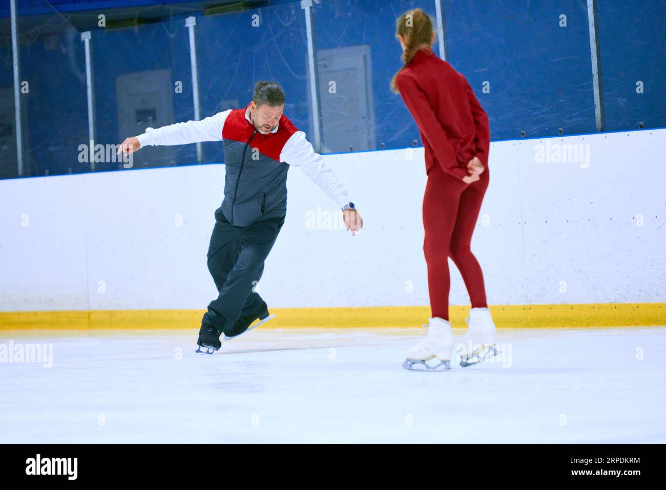 Professional skater, man training girl, learning figure skating