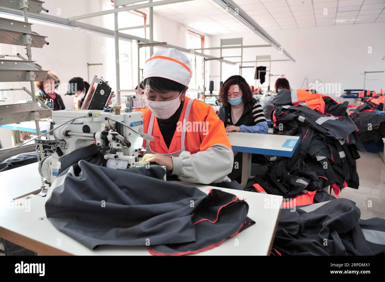 (190808) -- BEIJING, Aug. 8, 2019 -- Workers process clothes at a poverty alleviation workshop in Yingshouyingzi coal mining quarters of Chengde, north China s Hebei Province, May 5, 2019. China has seen rapid income and consumption growth in rural areas over the past 70 years, according to a report from the National Bureau of Statistics (NBS). In 2018, rural per capita disposable income had increased 40 times from 1949 to stand at 14,617 yuan (about 2,088 U.S. dollars) in real terms after deducting price factors, up 5.5 percent on average annually, the NBS said. The country s urban-rural inco Stock Photo